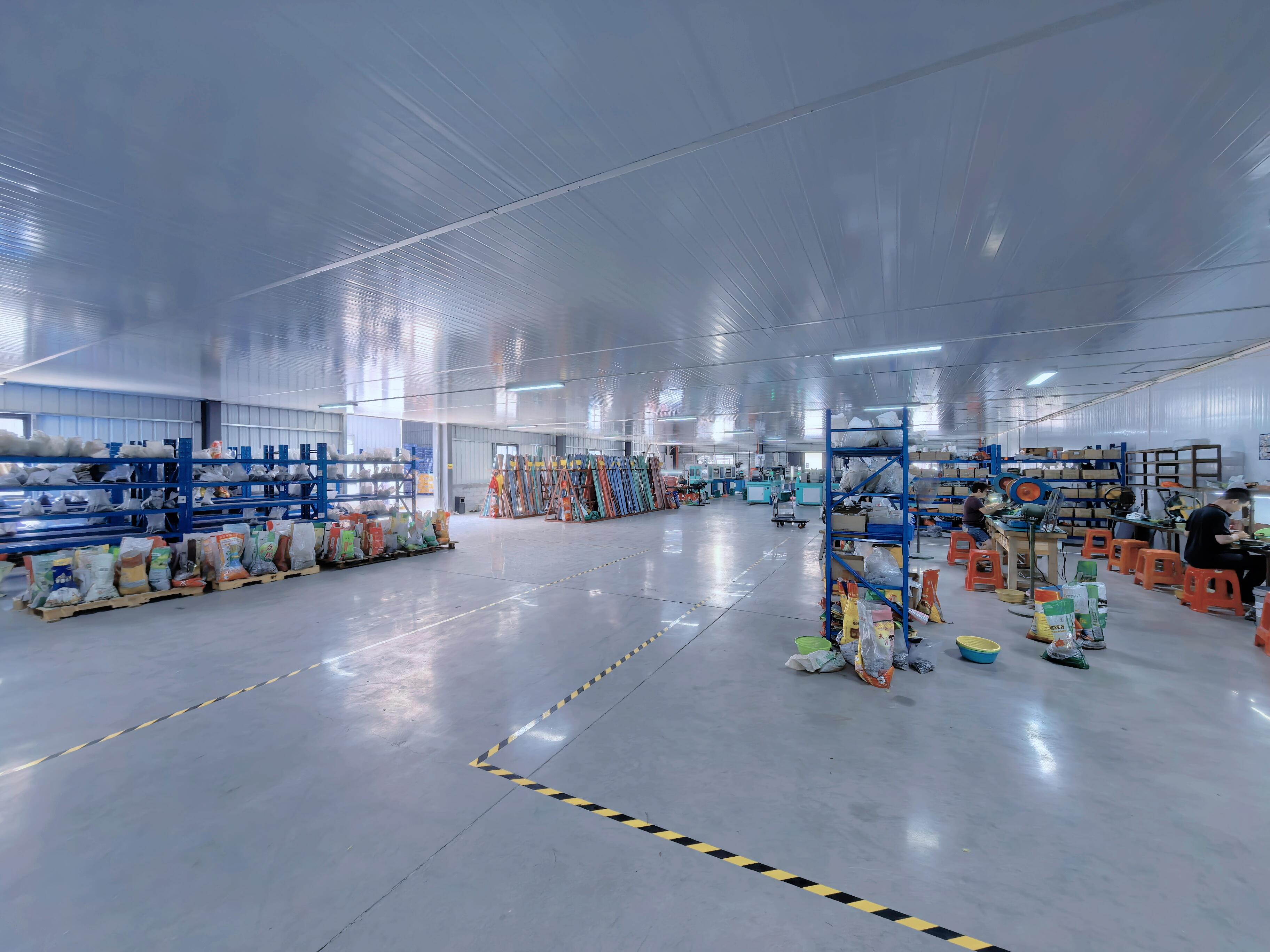 Factory floor showing workstations and material racks